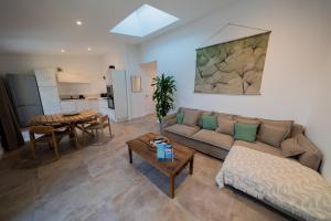 a living room with a couch and a table at La maison du Port Apt MARSA in Marseillan