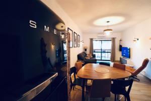 a dining room with a table and a couch at Vilamoura 2 Bedroom with Pool - Na Casa De Pascal in Vilamoura