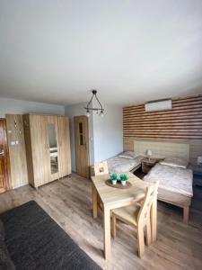 a living room with a table and a bed at Pokoje gościnne Anna in Milicz
