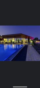 a lit up building with a pool at night at Damien in Bad Bergzabern