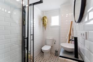 La salle de bains blanche est pourvue de toilettes et d'un lavabo. dans l'établissement La Casita Beneroso, à Alcalá de los Gazules