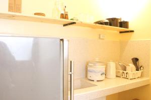 a kitchen with a counter top with a shelf at Urban Oasis Resort, Tarlac in Tarlac