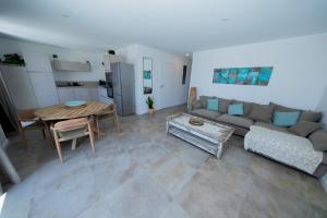 a living room with a couch and a table at La maison du Port Apt ROMA in Marseillan