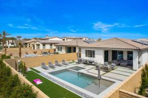 a backyard with a swimming pool and a house at PGA WEST New Pool & Spa Home in La Quinta