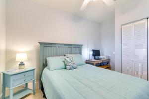 a bedroom with a blue bed with a night stand and a desk at Oceanfront Galveston Condo in Amazing Location! in Galveston +21 photos
