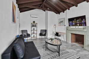 a living room with a couch and a table and a fireplace at Lovely 1 Bedroom Walking Distance To Ocean - Suite 1 in Hollywood