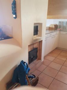 a kitchen with a fireplace in the corner of a room at Dachwohnung Unterem Hoereli in Vals