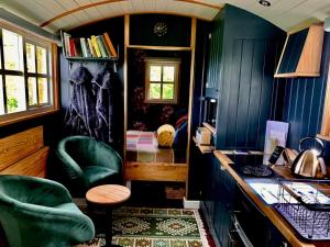 a home office with blue walls and green chairs at Church House Hut in Melton Mowbray