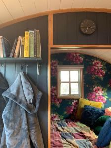 a bedroom with a bunk bed and a clock on a wall at Church House Hut in Melton Mowbray