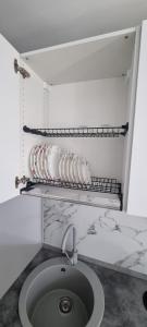 a bathroom with a sink and a counter with dishes at ELIAS LUXURY HOME in Constanţa