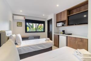 a hotel room with a bed and a tv at 360 Liberdade in Sao Paulo