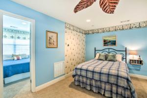 a bedroom with a bed and a blue wall at New Orleans Waterfront Home with Private Dock! in New Orleans