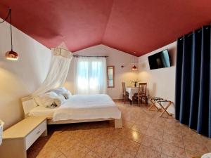 a bedroom with a bed and a room with a table at Poreč Villa Mihaela in Poreč +40 photos