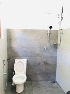 a bathroom with a toilet and a shower at Bluminz Homes in Katugastota