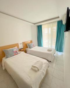 Postel nebo postele na pokoji v ubytování Mercan Otel
