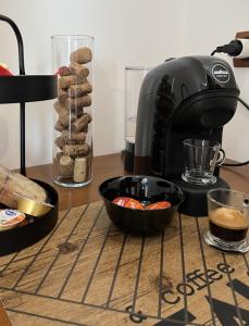 a coffee maker and a bowl of food on a table at B&B NoveUnoNoveQuattro in Apollosa