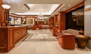 a lobby with chairs and a bar in a building at Fariyas Hotel Mumbai , Colaba in Mumbai