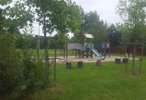 a playground with a slide in a park at Mieszkanie z ogródkiem in Wrocław