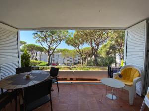 a patio with a table and chairs and a large window at Politur in Platja  d'Aro