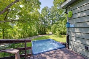 a hot tub on the deck of a house at Whittier Vacation Rental Cabin with Private Hot Tub in Whittier