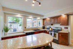 a kitchen with wooden cabinets and a counter top at Rapid City Home Near Parks and Hiking! in Rapid City