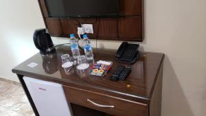 a desk with a telephone and bottles of water at Karam Inn in Aqaba