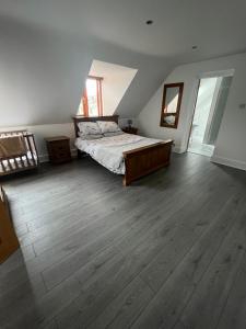 a bedroom with a bed and a wooden floor at *Heart of Johnston*Idyllic* in Johnston