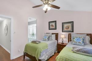 a bedroom with two beds and a ceiling fan at Cozy Glimmer in Canyon Lake