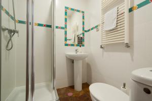 a bathroom with a toilet sink and a shower at Oasis Backpackers' Hostel Granada in Granada +99 photos