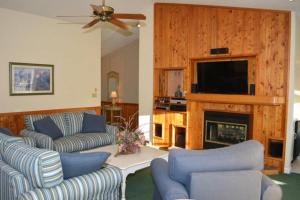 a living room with two couches and a fireplace at The Earnest at Ships Watch in Duck