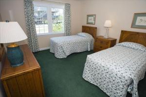 a hotel room with two beds and a window at The Earnest at Ships Watch in Duck