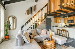 a living room with a couch and a staircase at Brian Head Vacation Rental Walk to Giant Steps! in Brian Head