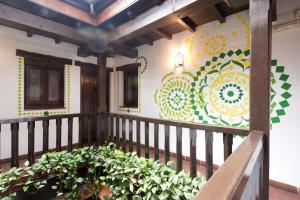 a balcony with a mural on the side of a building at Oasis Backpackers' Hostel Granada in Granada