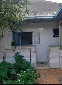 a house with a window in the side of it at morada da sagrada familia kit 2 in Guarapari +3 photos