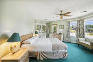 a bedroom with a bed and a ceiling fan at The Glane at Ships Watch in Duck +22 photos