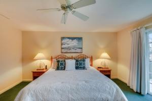 a bedroom with a bed with a ceiling fan at The Myllet at Ships Watch in Duck