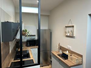 a kitchen with a stainless steel refrigerator and a counter at Cocooning coeur de Troyes in Troyes
