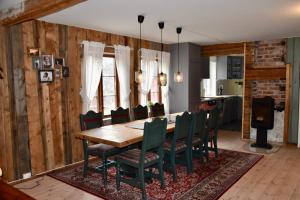 a dining room with a wooden table and chairs at Nedre Stensgården in Røros