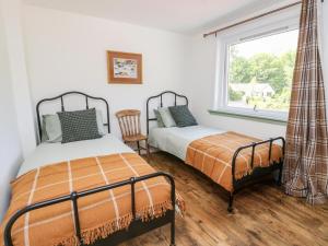 2 camas en una habitación con ventana en 1 Slatach, en Glenfinnan