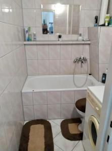 a bathroom with a tub and a toilet and a sink at U bram Bieszczad in Rzepedż