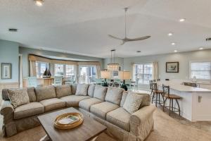a living room with a couch and a kitchen at The Tappan at Ships Watch in Duck