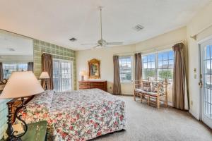 a bedroom with a bed and a chair and windows at The Tappan at Ships Watch in Duck +54 photos