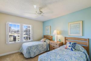 a bedroom with two beds and a window at The Wythers at Ships Watch in Duck +33 photos