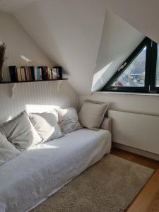 a bed in a room with a window at Rurstübchen in Simmerath