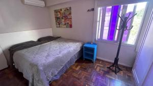 a small bedroom with a bed and a window at Amplo e iluminado apartamento na Gávea in Rio de Janeiro