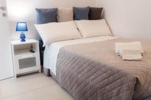 a bedroom with a large bed and a night stand at Gli Imperiali in Latiano