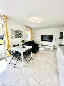 a living room with a table and a couch at Nice Apartment Disneyland Paris in Chessy