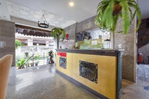 a lobby with a bar with plants in it at 21 hotel in Pattaya