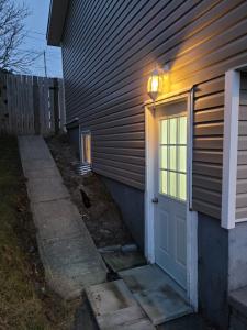 a door with a light on the side of a house at Full 1-bedroom apartment in St. John's