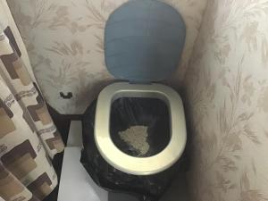 a bathroom with a toilet with the seat up at VINTAGE CARAVANE in Les Attaques +78 photos